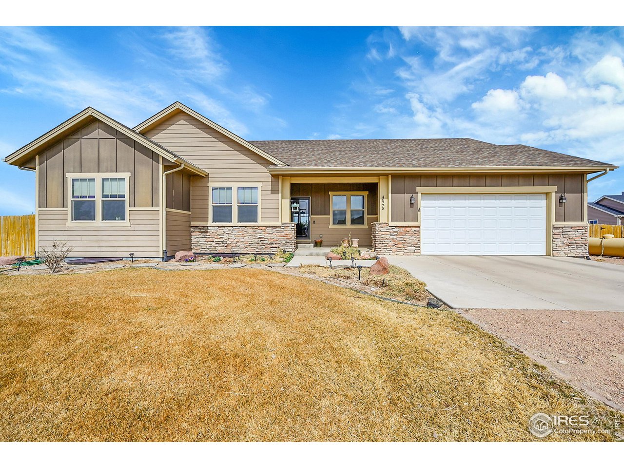 40775 Jade Drive Ault, CO 80610 - Photo 2 of 40 a front view of a house with yard and parking