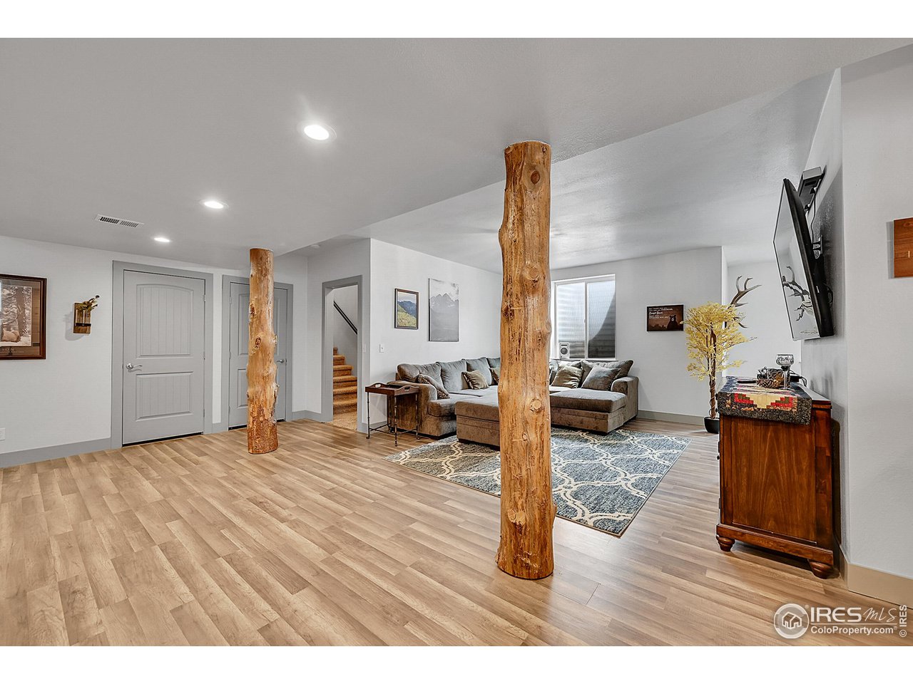 40775 Jade Drive Ault, CO 80610 - Photo 27 of 40 a living room with furniture and a flat screen tv