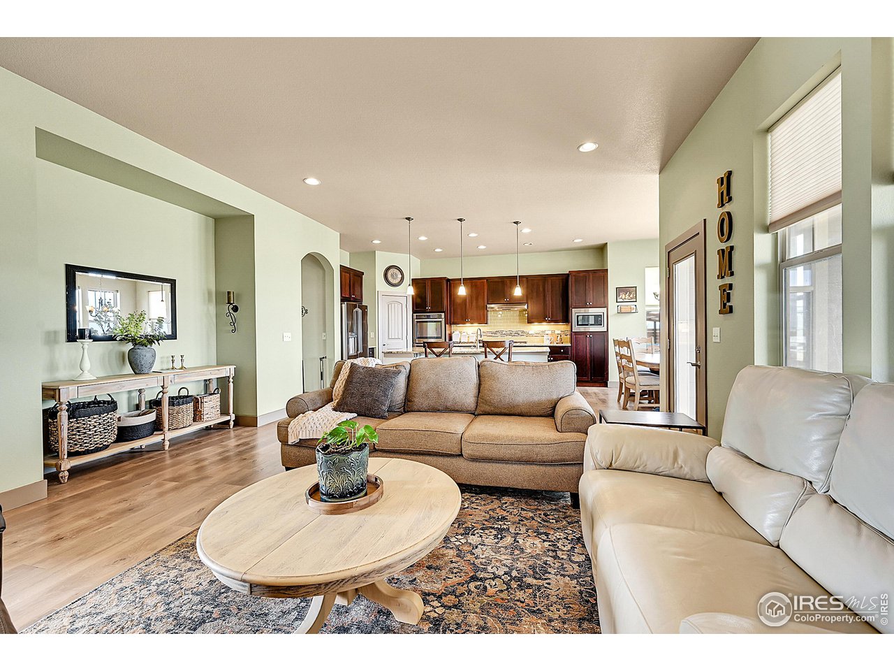 40775 Jade Drive Ault, CO 80610 - Photo 6 of 40 a living room with furniture kitchen view and a wooden floor