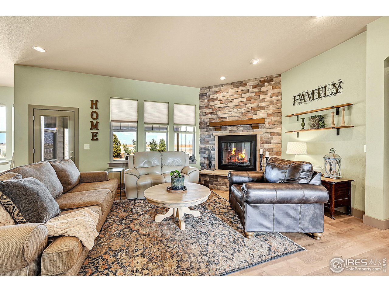 40775 Jade Drive Ault, CO 80610 - Photo 7 of 40 a living room with furniture fireplace and a large window