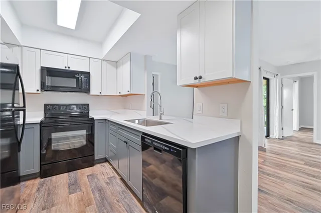 a kitchen with kitchen island a sink appliances and cabinets