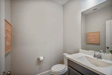 a bathroom with a sink toilet and vanity