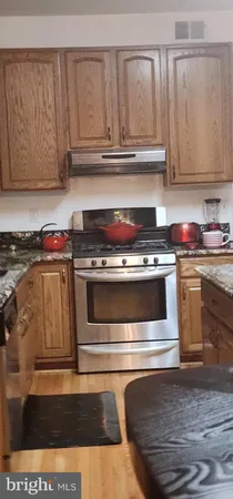a stove top oven sitting inside of a kitchen