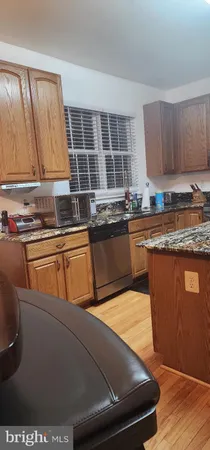 a kitchen with stainless steel appliances granite countertop a sink and cabinets