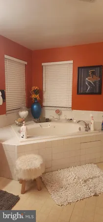 a bed sitting in a bedroom next to a lamp
