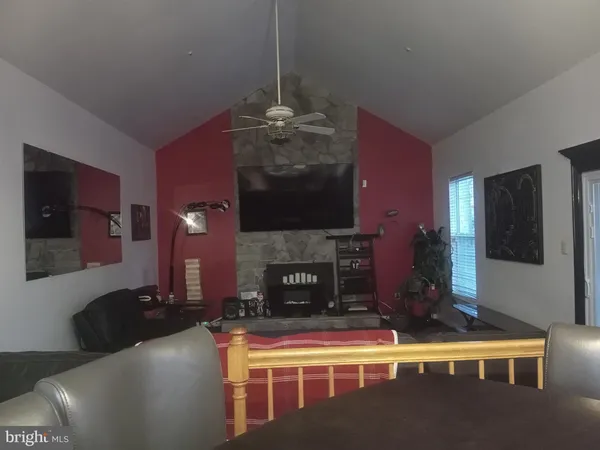 a living room with fireplace furniture and a fireplace
