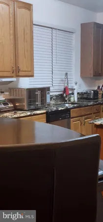 a kitchen with stainless steel appliances a sink dishwasher a stove and a refrigerator