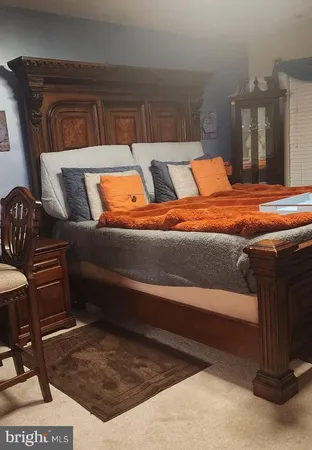 a bed sitting in a bedroom next to a lamp