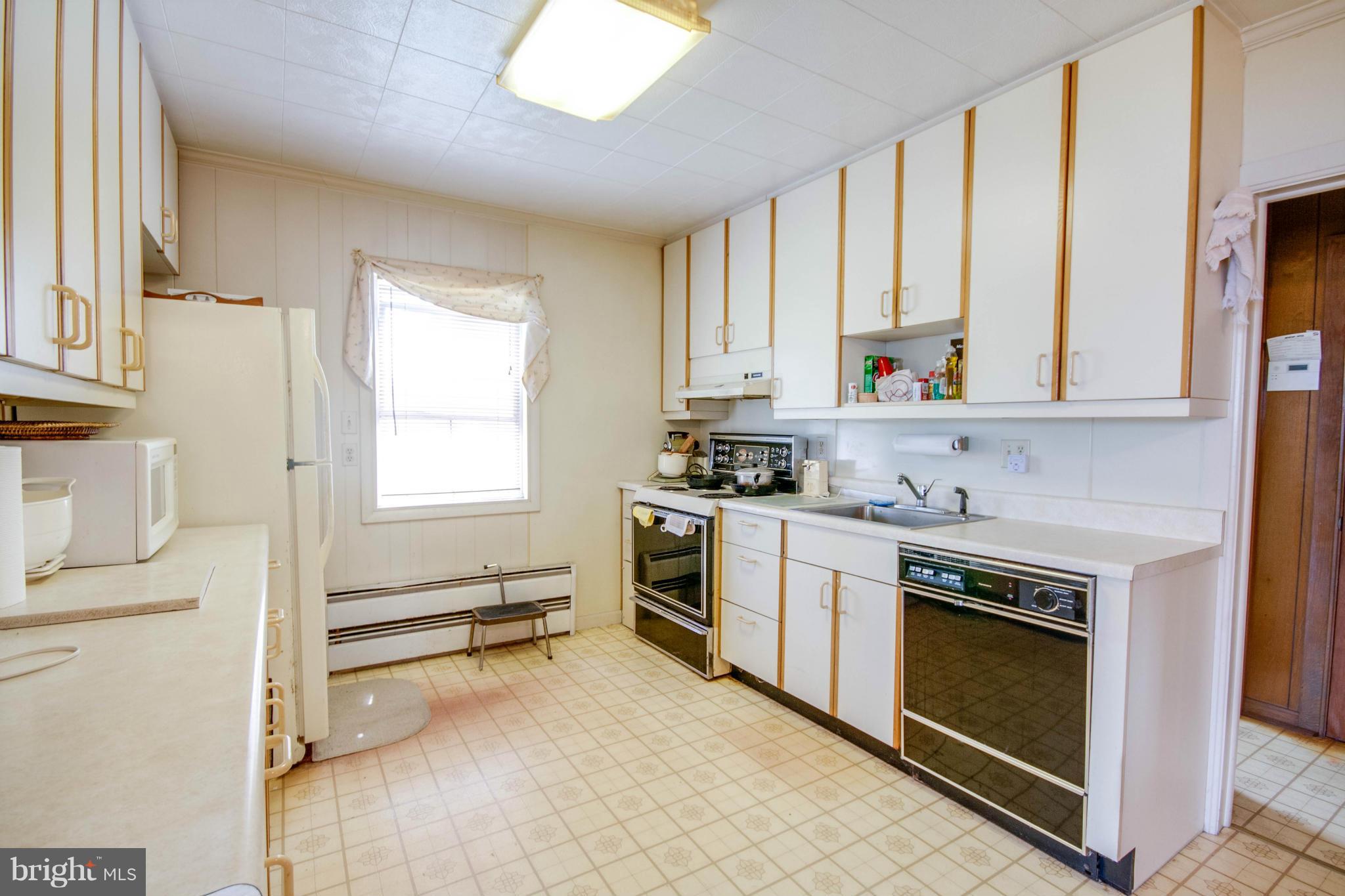 38130 Graves Road Coltons Point, MD 20626 - Photo 13 of 30 a kitchen with white cabinets and appliances