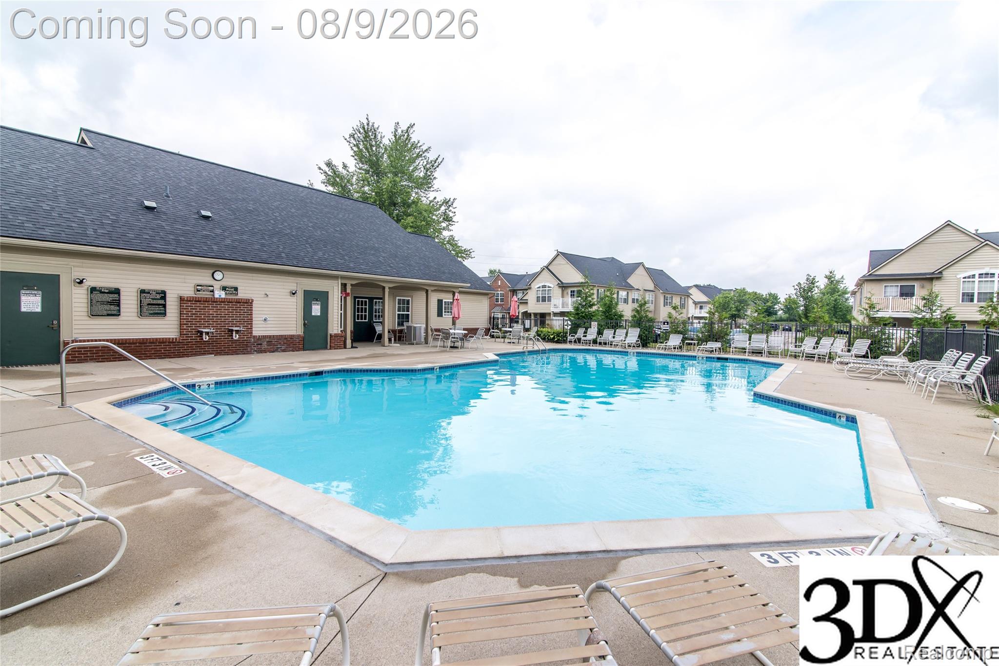 4256 Hampton Ridge Boulevard Howell, MI 48843 - Photo 8 of 26 Community swimming pool with concrete decking and adjacent building
