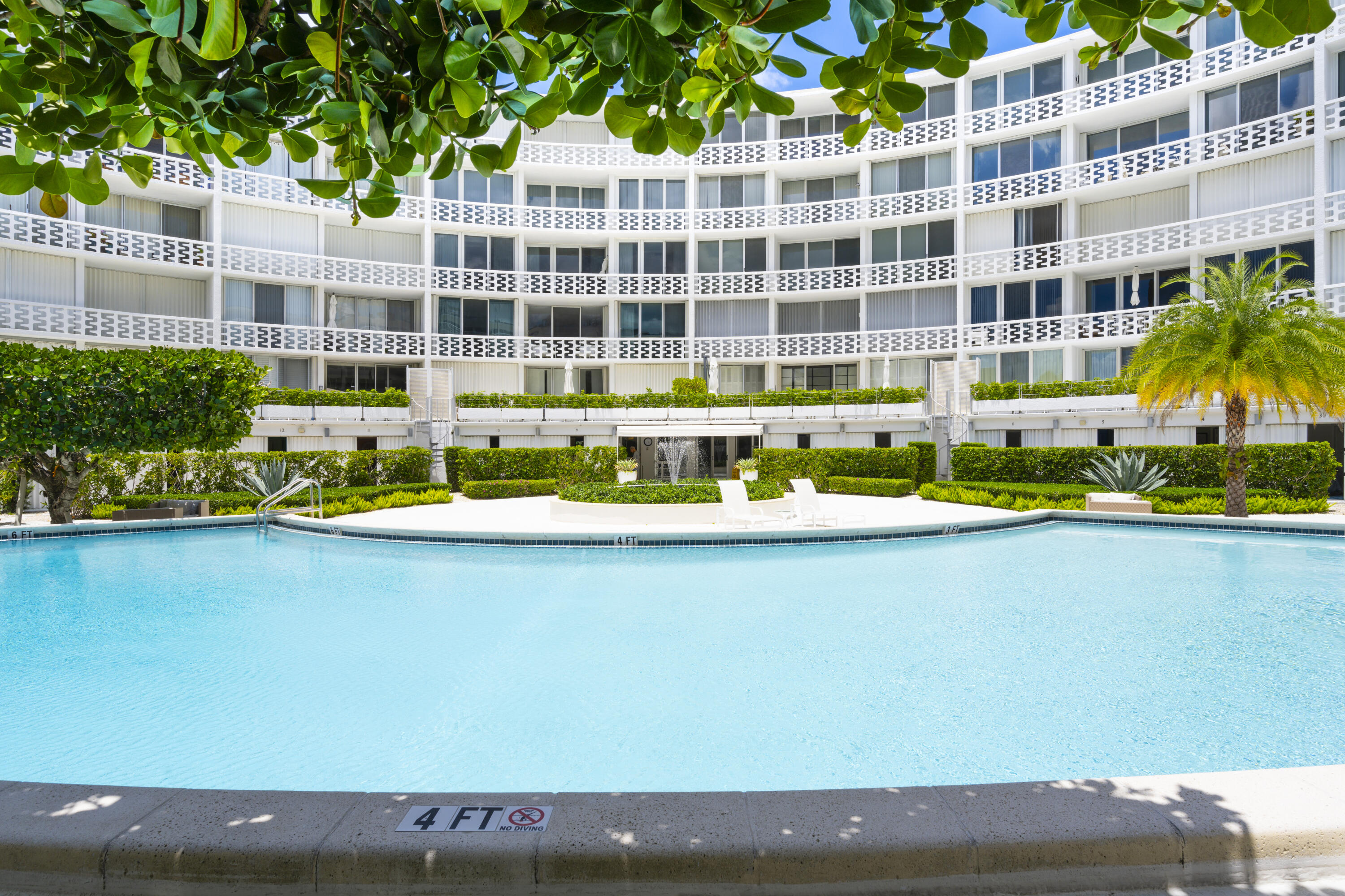2760 South Ocean Boulevard, Unit 213 Palm Beach, FL 33480 - Photo 15 of 24 a view of swimming pool with outdoor seating and buildings in the background