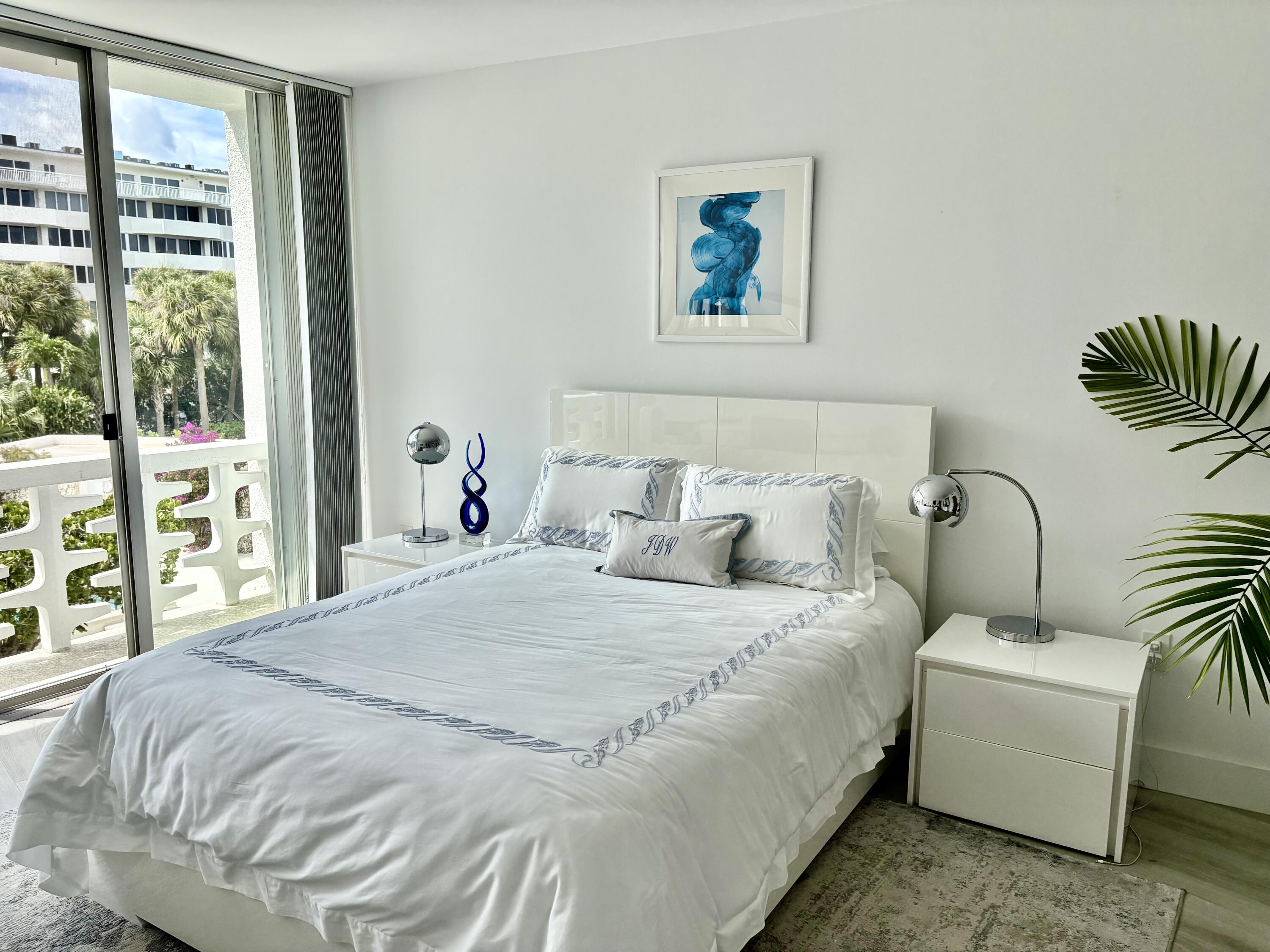 2760 South Ocean Boulevard, Unit 213 Palm Beach, FL 33480 - Photo 8 of 24 a bedroom with bed and a large window
