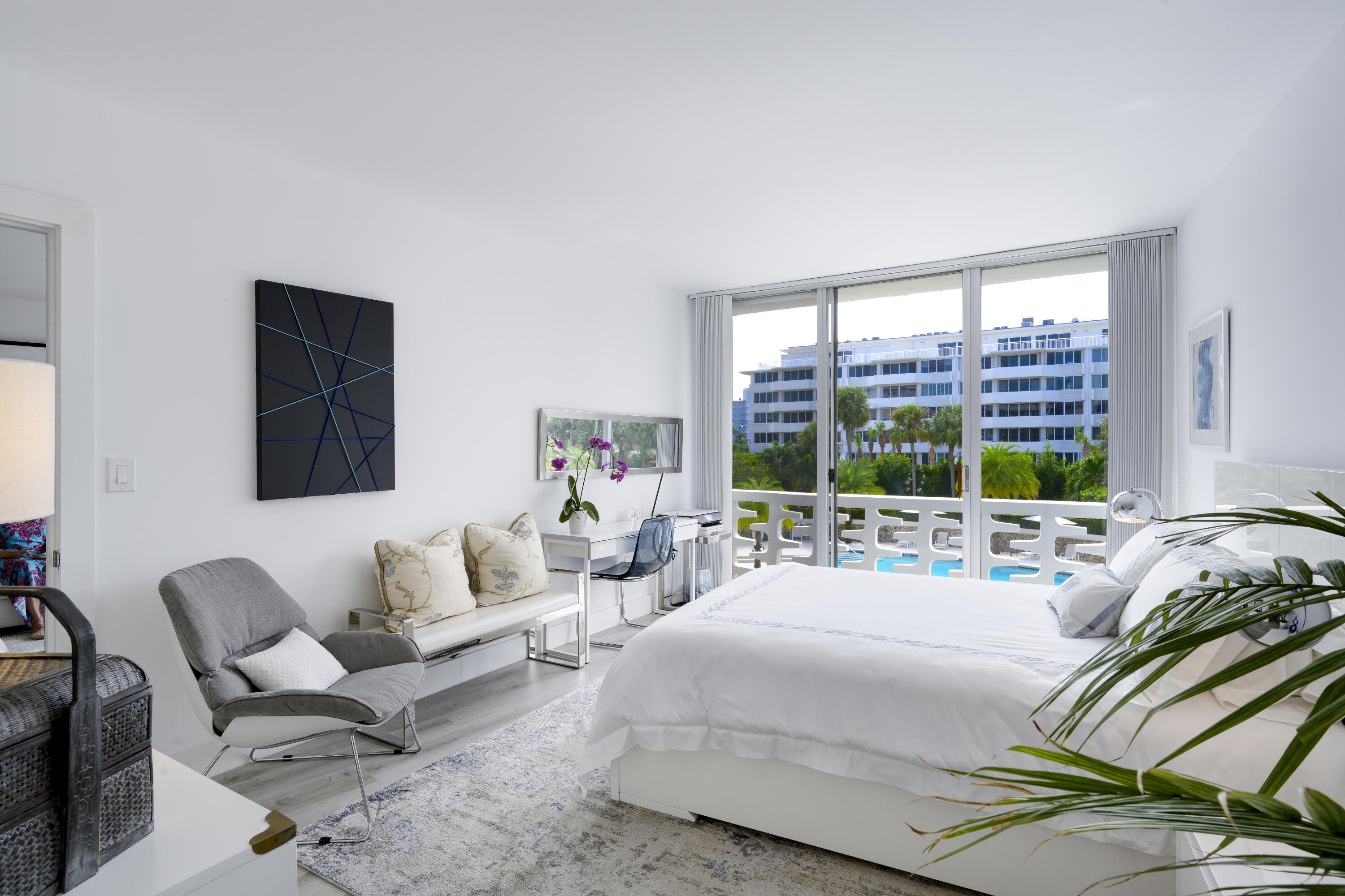 2760 South Ocean Boulevard, Unit 213 Palm Beach, FL 33480 - Photo 9 of 24 a bedroom with a bed and a large window