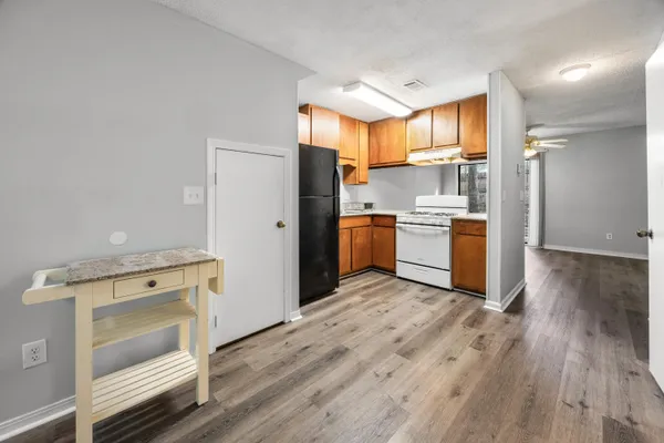 a kitchen with a stove a refrigerator and a stove top oven
