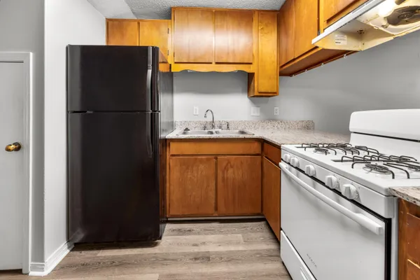 a kitchen with a refrigerator and a sink