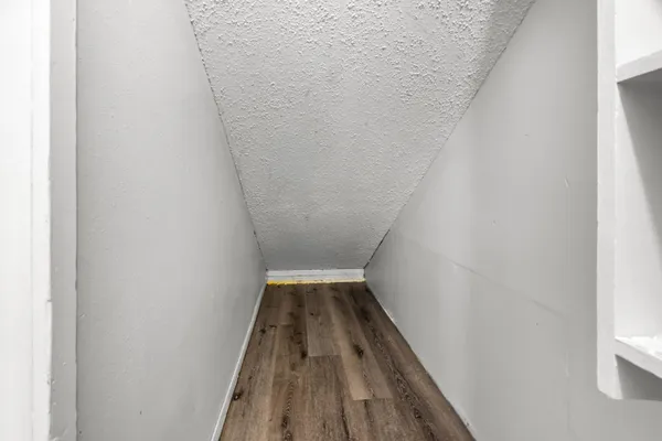 a view of wooden floor in a hallway