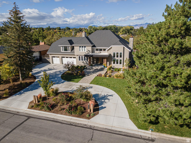 8364 Etienne Way Sandy, UT 84093 - Photo 1 of 1 View of front facade with covered porch, concrete driveway, a chimney, and a garage