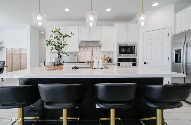 a kitchen with stainless steel appliances granite countertop white cabinets and a sink