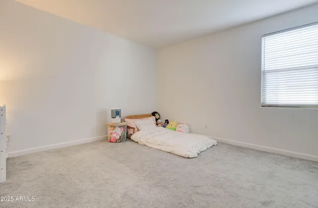 a bedroom with a bed and a desk