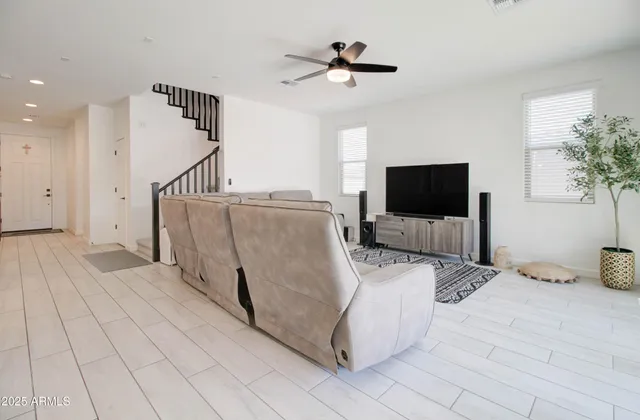 a living room with furniture and a large window