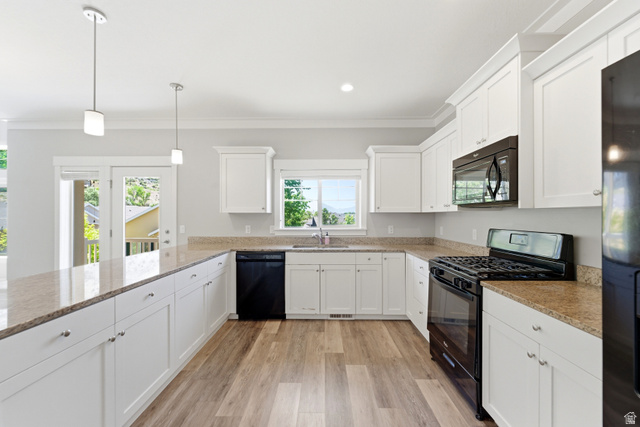 1614 Aspen Loop Provo, UT 84606 - Photo 15 of 47 Bright kitchen featuring white shaker cabinetry, stone-look countertops, and stainless steel appliances