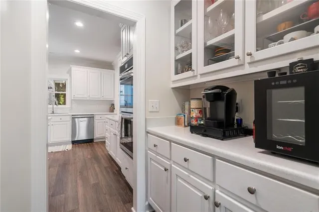a bathroom with a double vanity sink mirror and next to a window