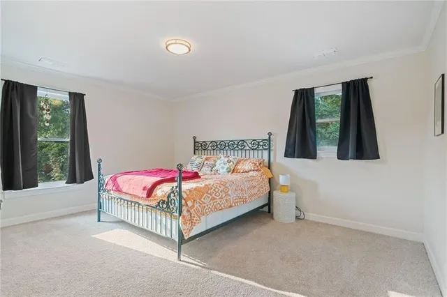 a front view of a house with a yard and green space