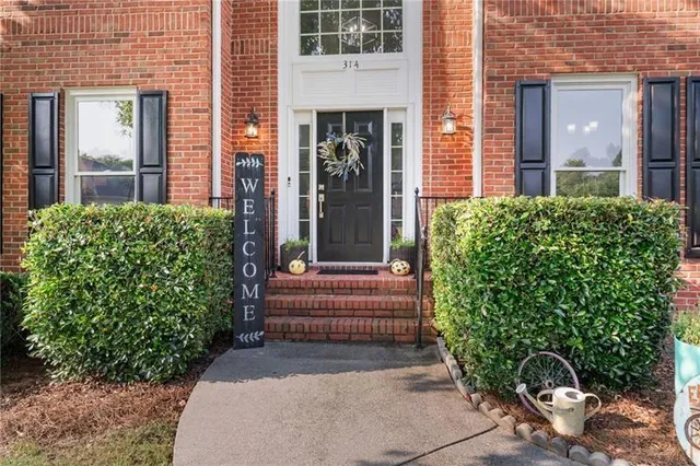 a front view of a house with garden