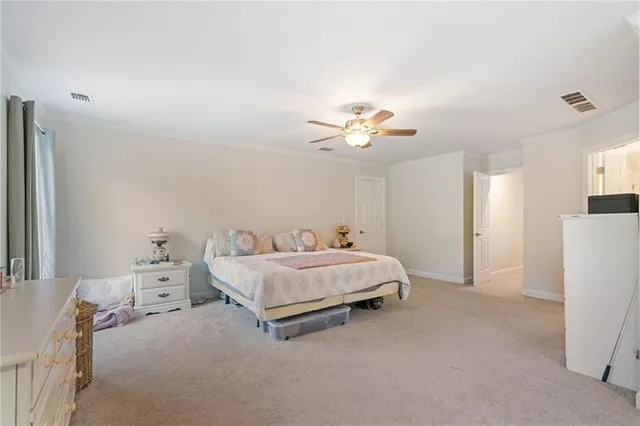 a front view of a house with a yard and trees