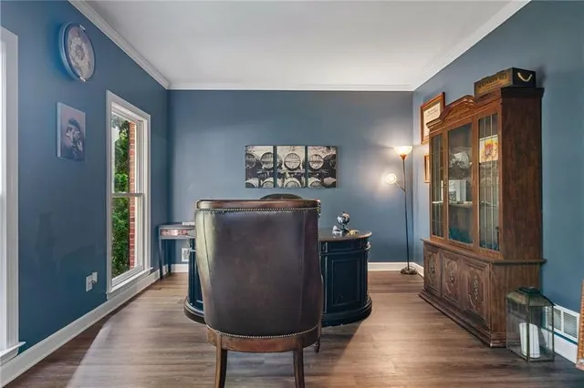 a dining room with furniture and wooden floor