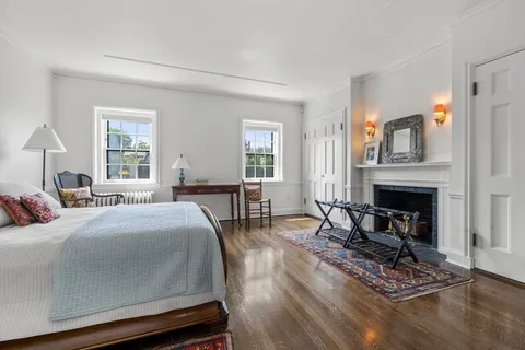 a bedroom with a bed couch and a window