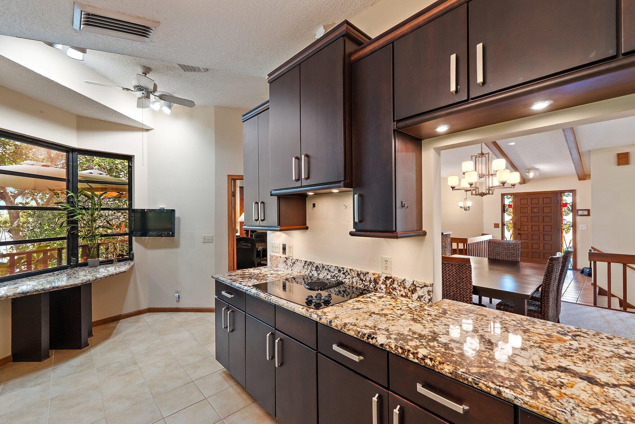702 Warren Drive Jupiter, FL 33458 - Photo 40 of 76 a kitchen with stainless steel appliances granite countertop a stove and a sink