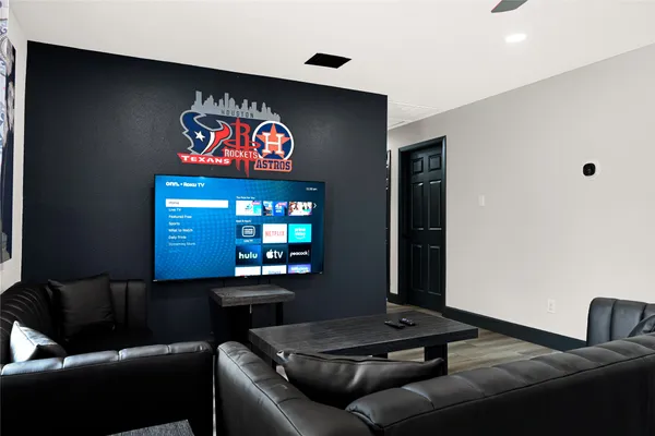 a room with pool table and windows