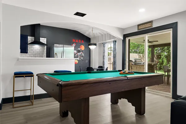 a front view of a dining room with furniture and chandelier