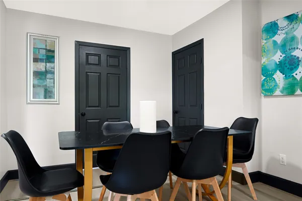 a kitchen with stainless steel appliances a refrigerator a stove a sink and chairs