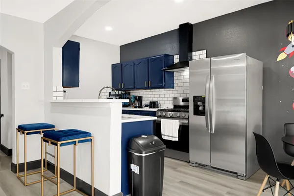 a kitchen with stainless steel appliances granite countertop a stove and a cabinets