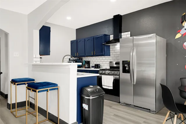 a kitchen with stainless steel appliances granite countertop a stove and a cabinets