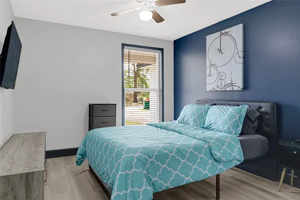 a bedroom with a bed and a flat screen tv