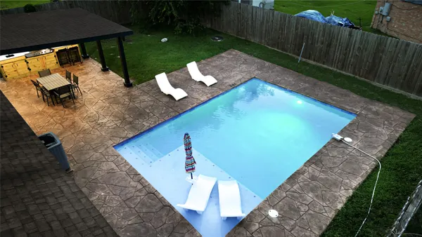 a view of a backyard with sitting area