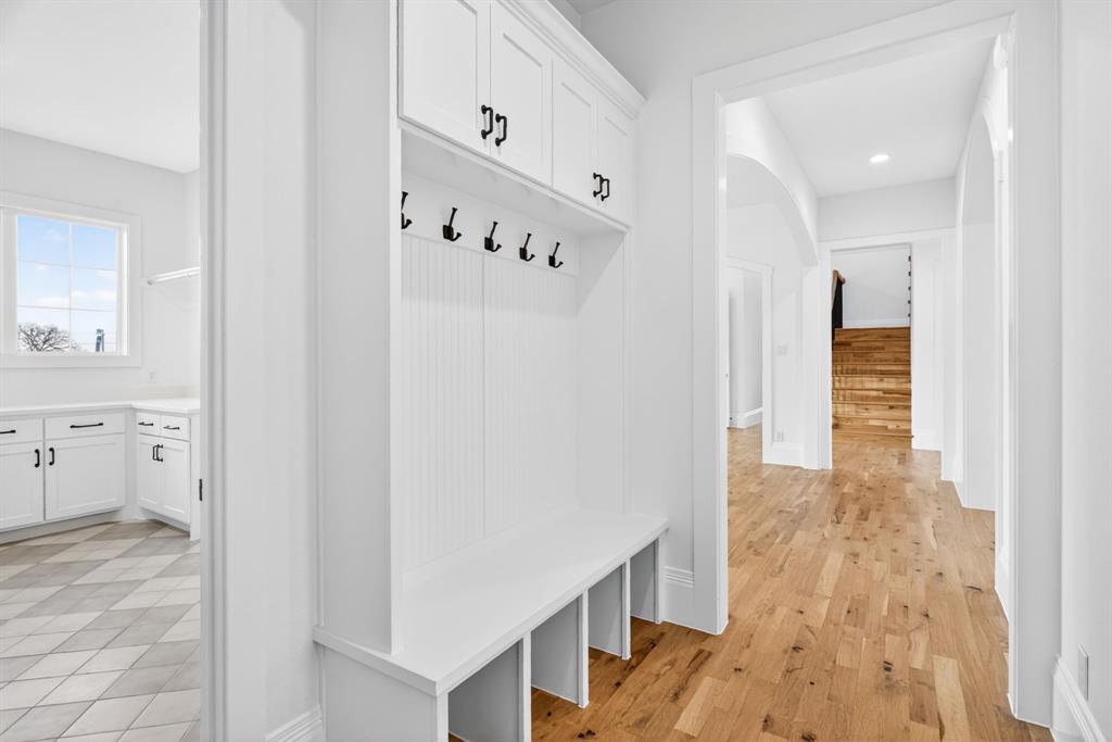 7798 Barber Rnch Road Fort Worth, TX 76126 - Photo 14 of 40 a view of a hallway with wooden floor and staircase