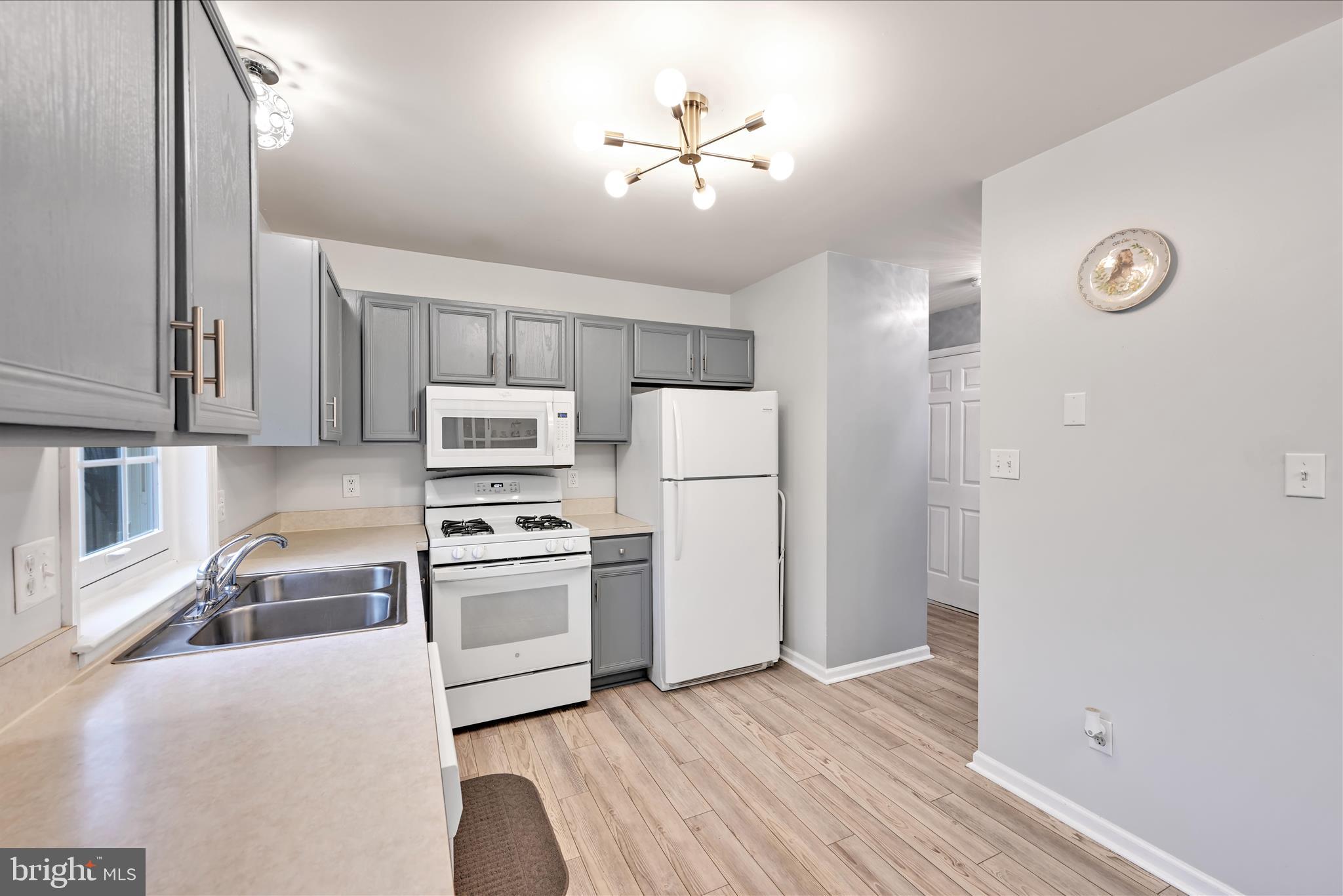 160 Riders Way Lebanon, PA 17042 - Photo 14 of 29 a kitchen with stainless steel appliances a stove a refrigerator and a sink with wooden floor