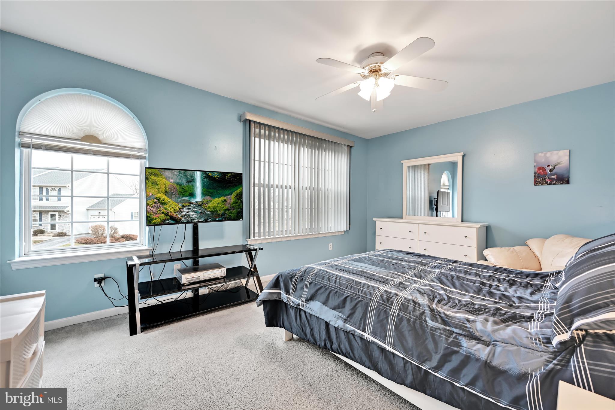 160 Riders Way Lebanon, PA 17042 - Photo 20 of 29 a bedroom with a bed a chandelier and a window