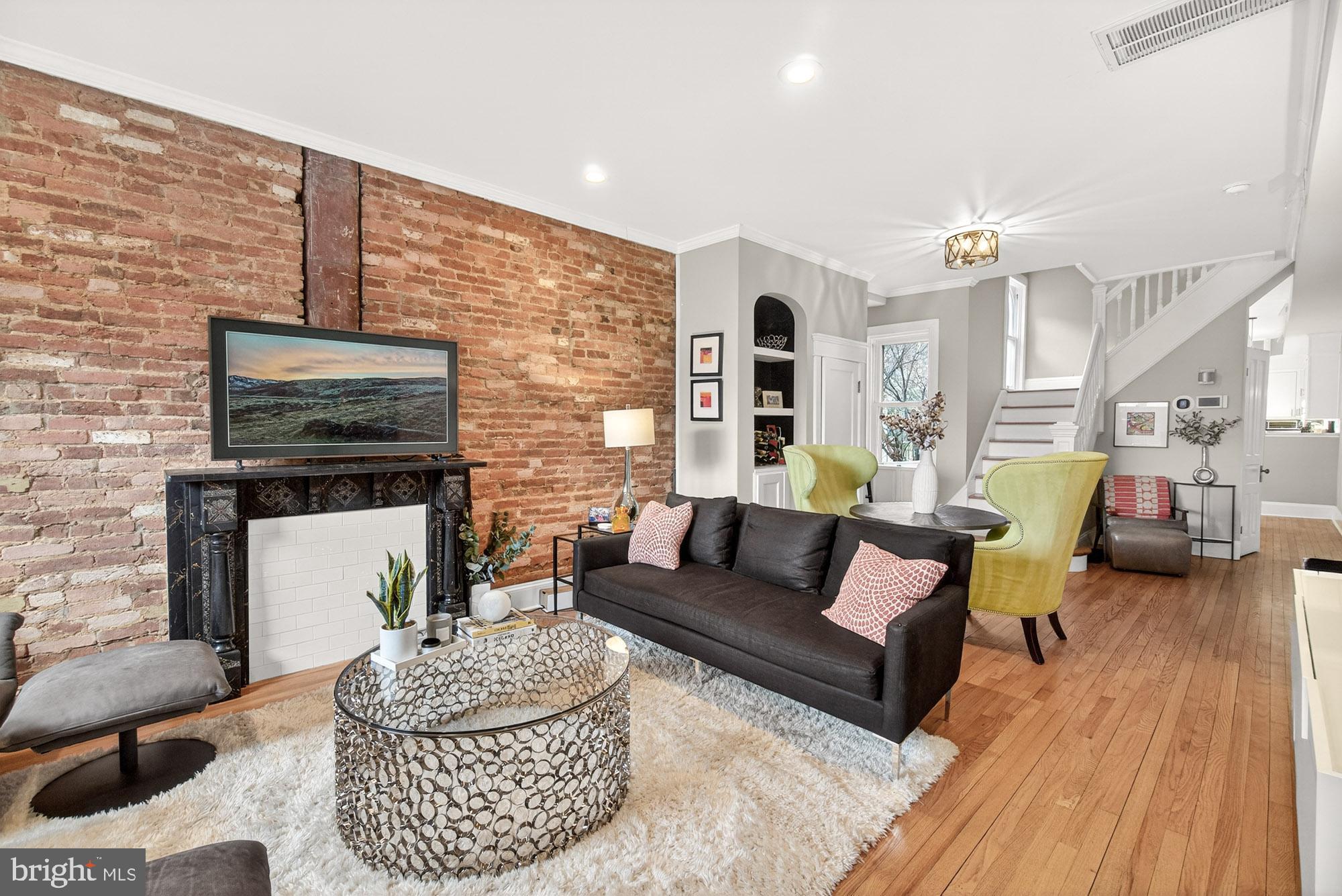 a living room with furniture and a fireplace