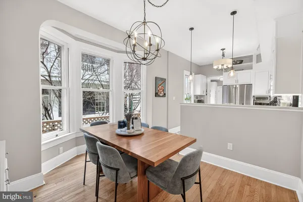 a view of a dining room with furniture wooden floor and chandelier