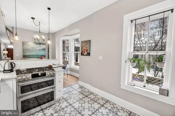 a kitchen with stainless steel appliances a refrigerator and a window