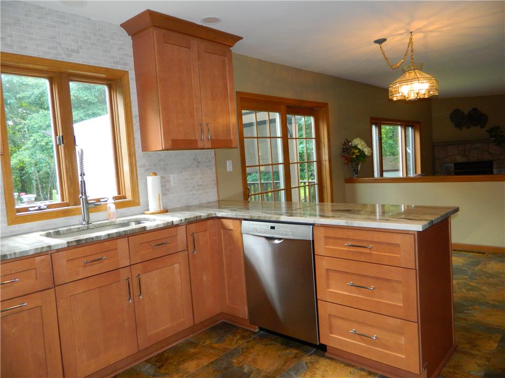 328 Pin Oak Road Stroudsburg, PA 18360 - Photo 22 of 42 A well-lit kitchen featuring natural wood cabinetry and a functional layout.