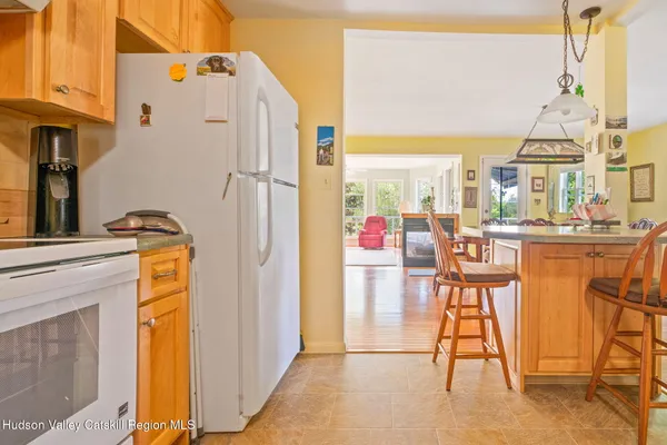 a kitchen with a refrigerator sink and cabinets