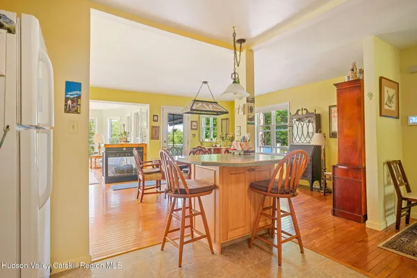 a dining room with furniture and wooden floor