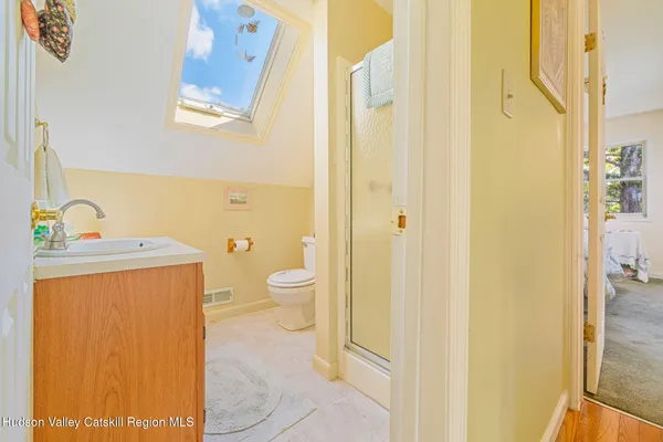 a bathroom with a sink a light fixture and a mirror