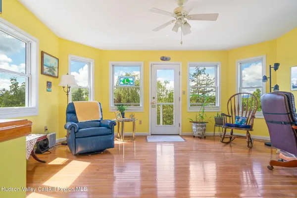 a living room with furniture and floor to ceiling windows